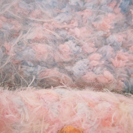 Close-up of textured fabric with pink and gray colors