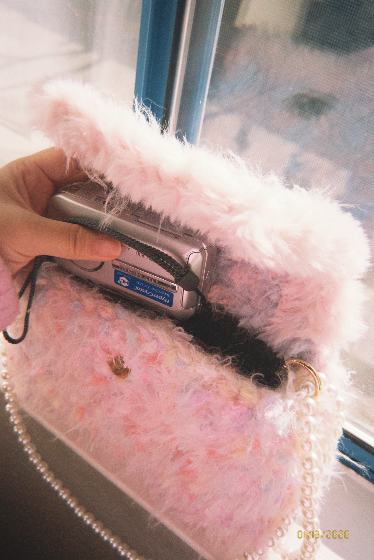 Someday she - Deleted Scenes one-of-a-kind hand-blended artisanal crochet shaggy bag in soft pink, with a vintage digital camera tucked inside and a pearl strap.