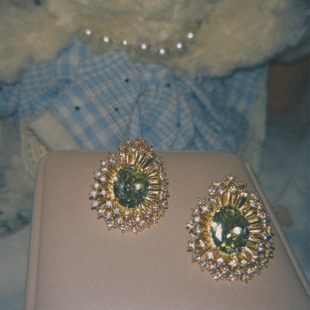 Someday she - The Green Library vintage emerald starburst halo statement studs, featuring deep green stones and a sparkling diamond-like halo on a beige cushion with a soft, retro film aesthetic.