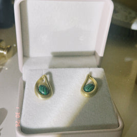 Someday she - The Green Light vintage-style gold drop earrings inlaid with green malachite stones, presented in a classic white jewelry box with soft dramatic lighting.